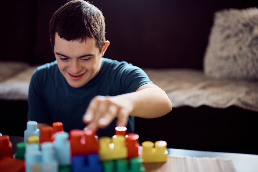  Disability Support For Children, Adults and Seniors - Calgary, AB | ComForCare - happy-down-syndrome-man-having-fun-while-playing-w-2023-11-27-05-32-53-utc